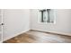 Bright bedroom featuring wood-look flooring and a large window, creating a serene living space at 2537 Lupton Ln, Lafayette, CO 80026