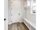 Functional entryway featuring a built-in bench with storage, shelving, and stylish wood-look flooring at 2537 Lupton Ln, Lafayette, CO 80026