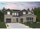 Inviting two-story home with stone and gray siding, featuring a two-car garage and manicured front lawn at 2537 Lupton Ln, Lafayette, CO 80026