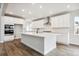 Modern kitchen featuring white cabinets, a large island, and stainless steel appliances at 2537 Lupton Ln, Lafayette, CO 80026