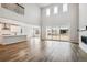 Bright, open-concept living room with hardwood floors, a fireplace, and sliding glass doors at 2537 Lupton Ln, Lafayette, CO 80026