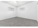 A carpeted bedroom is well-lit by two windows with venetian blinds at 109 6Th St, Fort Lupton, CO 80621