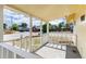 A quaint front porch with white railings overlooks a quiet street at 109 6Th St, Fort Lupton, CO 80621