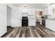 Clean kitchen with white cabinets, black appliances, and modern flooring at 109 6Th St, Fort Lupton, CO 80621