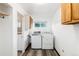 Bright laundry room featuring a side-by-side washer and dryer at 109 6Th St, Fort Lupton, CO 80621