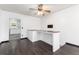 Cozy living room with a breakfast bar, ceiling fan, and open access to the kitchen at 109 6Th St, Fort Lupton, CO 80621