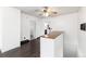 Bright living room with wood floors, ceiling fan, and open doorway to the kitchen at 109 6Th St, Fort Lupton, CO 80621