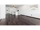 Open-concept living room with dark wood floors, breakfast bar, and great natural lighting at 109 6Th St, Fort Lupton, CO 80621