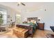 Bright bedroom with hardwood floors, wooden furniture, a ceiling fan and a balcony at 5401 S Park Terrace Ave # 301C, Greenwood Village, CO 80111