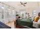 Bright bedroom featuring large windows with natural light, ceiling fan, and cozy seating area at 5401 S Park Terrace Ave # 301C, Greenwood Village, CO 80111