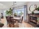 Well-lit dining area with fireplace, hard wood floors, and decor at 5401 S Park Terrace Ave # 301C, Greenwood Village, CO 80111