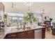 Open kitchen with stainless appliances, granite countertop, and balcony access at 5401 S Park Terrace Ave # 301C, Greenwood Village, CO 80111