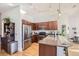 Kitchen with granite counters, stainless appliances, wood floors, and wooden cabinetry at 5401 S Park Terrace Ave # 301C, Greenwood Village, CO 80111