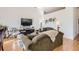 Bright and airy living room with hardwood floors, sofa, and entertainment center at 5401 S Park Terrace Ave # 301C, Greenwood Village, CO 80111