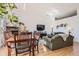 Bright living room featuring hardwood floors, comfortable seating, fireplace, and dining area at 5401 S Park Terrace Ave # 301C, Greenwood Village, CO 80111