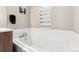 Bright bathroom featuring a soaking tub with marble tile surround and modern fixtures at 2622 W 24Th Ave # 2, Denver, CO 80211