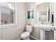 Cozy powder room featuring a pedestal sink, toilet, and contemporary fixtures with a large window at 2622 W 24Th Ave # 2, Denver, CO 80211