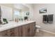 Well-lit bathroom with stylish wood grain cabinets, double sinks and modern countertops at 2622 W 24Th Ave # 2, Denver, CO 80211