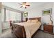 Cozy bedroom featuring a queen bed, ceiling fan, and a sunlit window with blinds at 2622 W 24Th Ave # 2, Denver, CO 80211