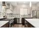 Well-equipped kitchen with stainless steel range, dark wood lower cabinets, and mosaic tile backsplash at 2622 W 24Th Ave # 2, Denver, CO 80211