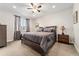 Comfortable main bedroom featuring plush bedding, a ceiling fan, carpet, and natural light at 2622 W 24Th Ave # 2, Denver, CO 80211