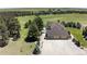 Aerial view of a large home with a well-manicured lawn and a trampoline in the backyard at 36412 Paradise Cir, Elizabeth, CO 80107