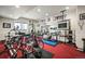 Bright basement gym featuring exercise equipment, free weights, and a wall-mounted TV at 36412 Paradise Cir, Elizabeth, CO 80107