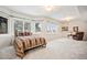Large bedroom with natural light and multiple windows offering outdoor views, plus a seating area at 36412 Paradise Cir, Elizabeth, CO 80107