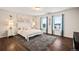 Bright bedroom with beach-themed decor, a plush rug, and two large windows overlooking a scenic view at 36412 Paradise Cir, Elizabeth, CO 80107