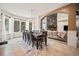 Elegant dining room with large windows, an open concept, and stone fireplace, perfect for Gathering gatherings at 36412 Paradise Cir, Elizabeth, CO 80107