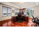 Home office with built in shelving, a large arched window, and a view of the surrounding landscape at 36412 Paradise Cir, Elizabeth, CO 80107