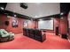 Home theater room features a projector screen, comfortable seating, and dark walls at 36412 Paradise Cir, Elizabeth, CO 80107