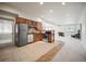 Open-concept kitchen with stainless steel appliances, wood cabinets, and adjacent living space at 36412 Paradise Cir, Elizabeth, CO 80107