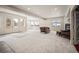 Expansive living room with multiple windows, bright natural light, and a view to the backyard patio at 36412 Paradise Cir, Elizabeth, CO 80107