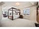 Spacious main bedroom suite with a four-poster bed, bay window, and cozy reading nook at 36412 Paradise Cir, Elizabeth, CO 80107