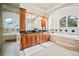 Luxurious primary bathroom features dual sinks, granite countertops, and a soaking tub with a view at 36412 Paradise Cir, Elizabeth, CO 80107