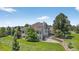 A sprawling home with a walkout patio, multiple windows, and well-maintained landscaping, providing ample outdoor space at 36412 Paradise Cir, Elizabeth, CO 80107