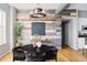 Dining area with a rustic accent wall, hardwood floors, and elegant lighting at 1489 Steele St # 104, Denver, CO 80206