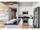 Modern kitchen featuring stainless steel appliances, white cabinets and a breakfast bar at 1489 Steele St # 104, Denver, CO 80206