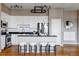 Bright kitchen with stainless steel appliances, breakfast bar, and modern lighting at 1489 Steele St # 104, Denver, CO 80206