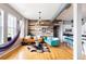 Bright living room featuring hardwood floors, modern decor, and a unique reclaimed wood accent wall at 1489 Steele St # 104, Denver, CO 80206