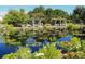 Scenic view of pond featuring trees, flowers, and a gazebo at 1489 Steele St # 104, Denver, CO 80206