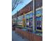 Charming Mezcal restaurant exterior with colorful window decorations, festive lighting, and inviting outdoor seating area at 1489 Steele St # 104, Denver, CO 80206