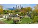 The Denver Zoo has a beautiful outdoor exhibit featuring elephants in a natural grassy habitat with Denver skyline at 1489 Steele St # 104, Denver, CO 80206