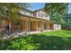 This backyard features a covered patio area with ample seating and beautiful grassy area, perfect for entertaining at 5755 S Fulton Way, Greenwood Village, CO 80111