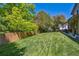 Large, well-maintained backyard with lush green grass and a privacy fence at 5755 S Fulton Way, Greenwood Village, CO 80111