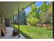A covered patio overlooks the lush backyard with green grass and mature trees at 5755 S Fulton Way, Greenwood Village, CO 80111