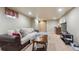 Spacious finished basement with a sectional sofa, TV and side bar area at 5755 S Fulton Way, Greenwood Village, CO 80111