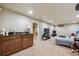 Finished basement area with a wet bar and comfortable seating and entertainment area at 5755 S Fulton Way, Greenwood Village, CO 80111