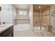 Bathroom featuring a bathtub, stand-alone shower with glass door, and sleek fixtures at 5755 S Fulton Way, Greenwood Village, CO 80111